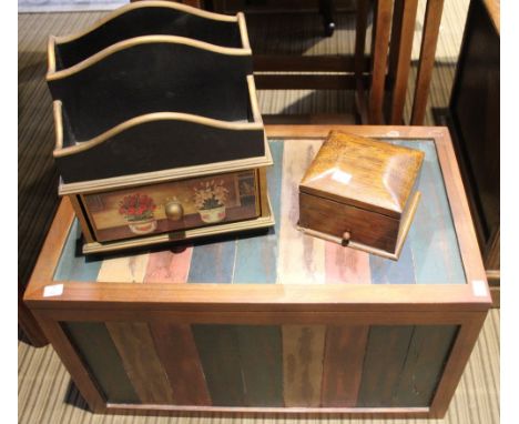 A small modern wood trunk together with a letter rack and a smokers box