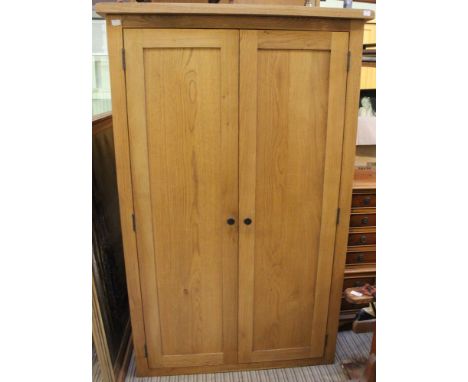 A modern light oak two door cupboard