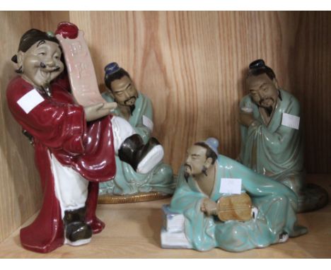 A shelf containing four Chinese ceramic figurines