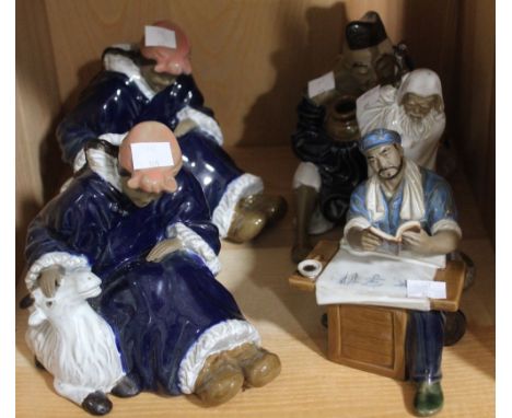 A shelf containing five Chinese ceramic figurines