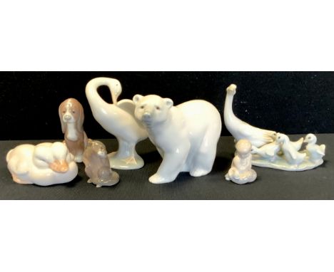 A Lladro porcelain figure Polar Bear;  three others Geese. puppy;  others Royal Copenhagen Otter and fish etc (7) 