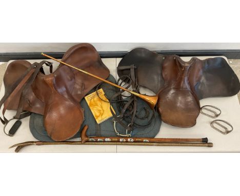 Equestrian - two leather saddles, a fleece under-saddle cushion;  stirrups, general tack;  a copper hunting horn;  Deer antle