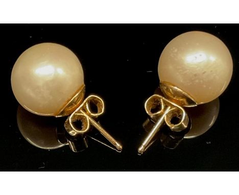A pair of cultured pearl earrings, unmarked yellow metal mounts, 3.5g gross 