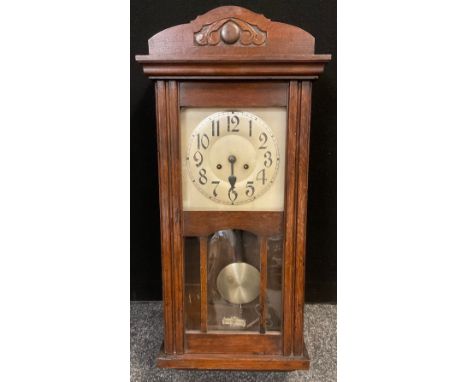 A 1930’s oak cased Vienna wall clock, silvered metal dial, Arabic numerals. 