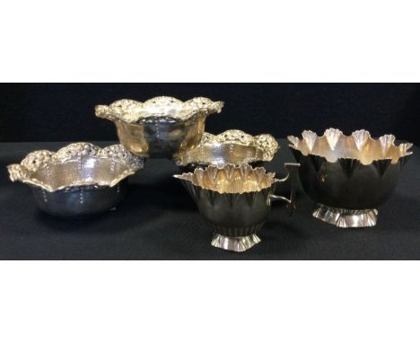 A set of three Chinese 800 silver bowls, planished body with floral undulating rim, stamped HR 800, 11.5cm diameter;  9.65ozt