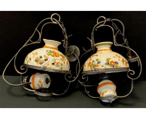 A pair of Italian wrought iron and pottery light fittings 