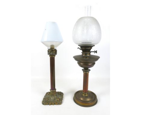 A Harrods Store oil lamp with a chimney and shade 86cm tall and a brass and copper candlestick with a shade