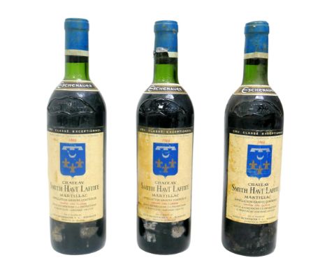 Vintage wine: three bottles of 1966 Chateau Smith Haut Lafite, Grand Cru Classe, Martillac, U: just below top of shoulder. (3