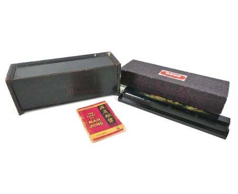 A 20th century Mahjong set, the ebonised case with removable front panel revealing four trays, filled with bamboo and bone pi