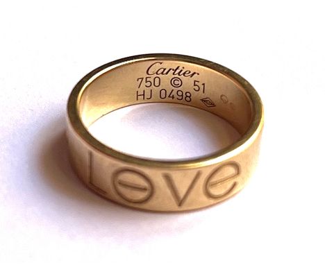 A vintage Cartier 18ct gold Love Collection ring, with original certificate and boxes, design engraved with the word LOVE com