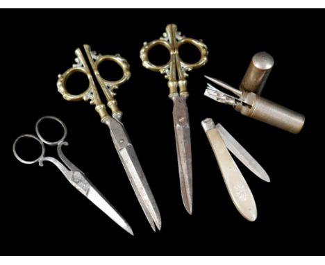 Two unusual pairs of 18th century scissors, possibly French, the brass handles cast with figures, on steel blades, 15cm long,