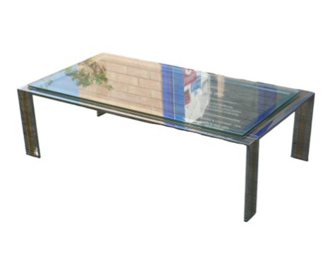 A vintage chromed metal and brass coffee table, with associated rectangular glass surface.The table has surface marks through