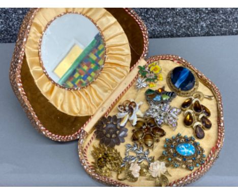 Case containing a mixture of costume jewellery brooches including Scottish &amp; 2 piece rose design brooch &amp; matching ri