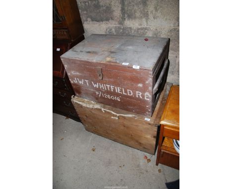 A trunk with the initials 'J.W.T. Whitfield RE' and an old pink trunk with stool.