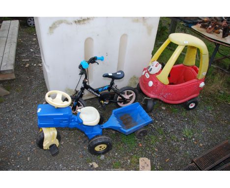 A Child's tractor and trailer, small bicycle, and a small 'Little Tike's' car