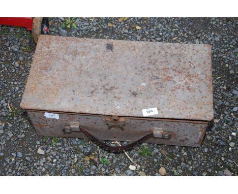 A metal toolbox containing wood brace bit, Stilsons, various old spanners, and  plastering trowels.