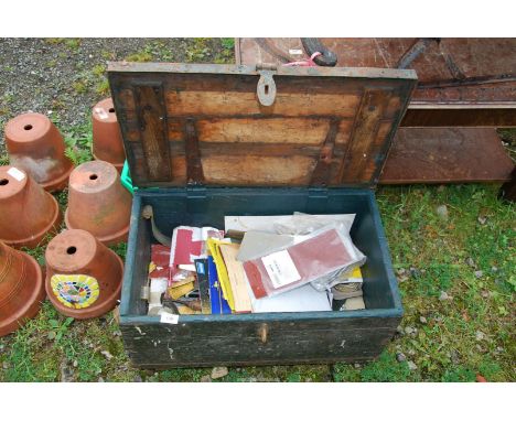 A wooden tool box containing sand paper and rubbing block.