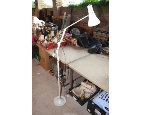 A floor standing angle-poise lamp.