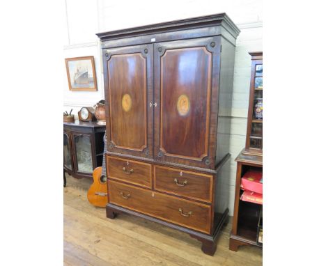 A George III mahogany and satinwood crossbanded linen chest, the cavetto moulded cornice over two panelled doors inlaid with 