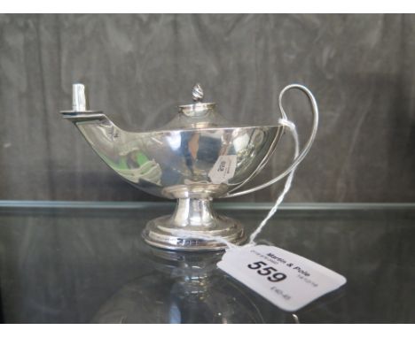 A silver cigarette lighter in the form of a genie's lamp, as found