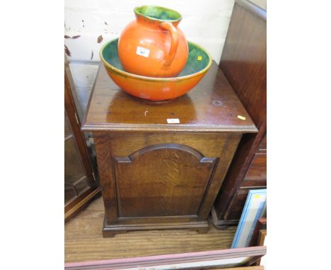 An oak cabinet in the George III style, with arched panel door and bracket feet, 56cm wide