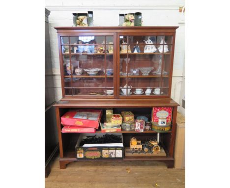 A mahogany bookcase, the top section with two glazed doors over open shelves on bracket feet, 143cm wide, 175cm high