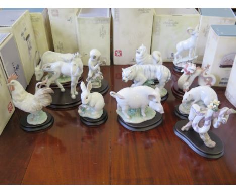 The Lladro Chinese Zodiac collection, twelve figurines each depicting an animal of the zodiac, on wooden bases, with original