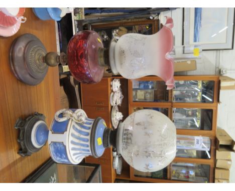 A Sevres Pate sur Pate style Victorian oil lamp on a metal base, 60cm high, and another oil lamp (2)
