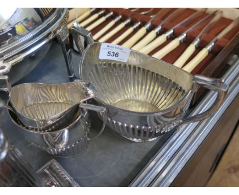 A four piece plated tea set, three matching, one odd sugar bowl