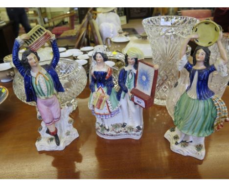 A pair of Victorian Staffordshire figures of musicians playing a tambourine and accordion, 34cm high, and another figure grou