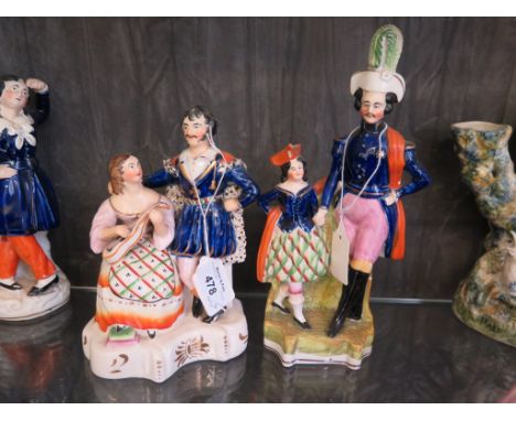 A Victorian Staffordshire figure group of a theatrical figure in an ermine cloak listening to a lady playing a guitar, 19cm h