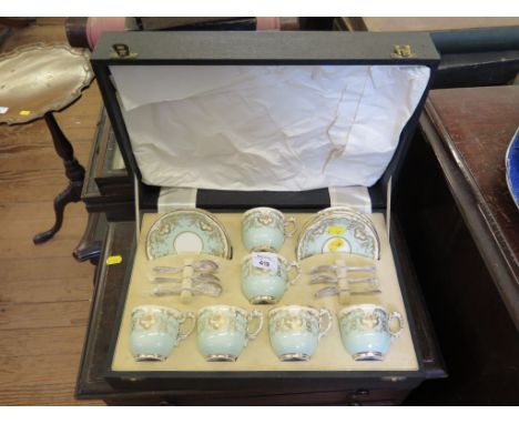 A cased set of six Royal Worcester coffee cans and saucers, with silver coffee spoons