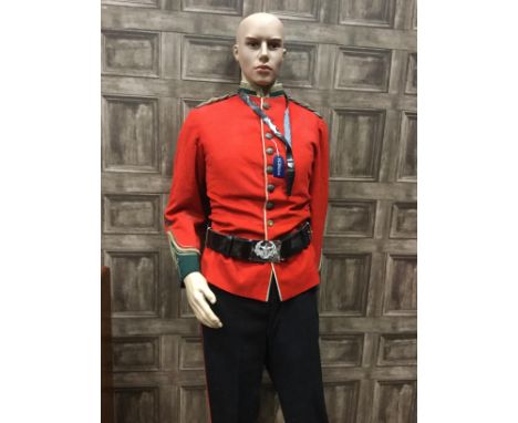 MODERN MANNEQUIN IN MILITARY DRESS, in a 19th Century crimson doublet, with kilt, Gordon Highlanders white leather cross belt