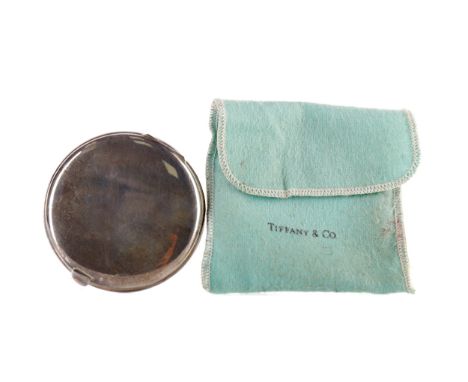 STERLING SILVER CIRCULAR COMPACT BY TIFFANY &amp; CO., The hinged cover with outset thumb piece, 7.5cm diameter