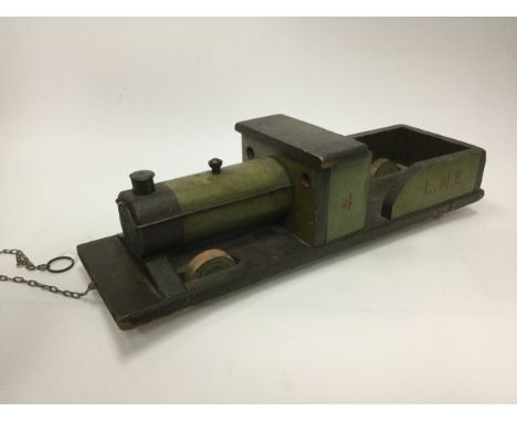 HANDMADE MODEL OF STEAM ENGINE, painted and carved wood, both sides inscribed '4, L.N.E', 66cm long Note: This model was repu