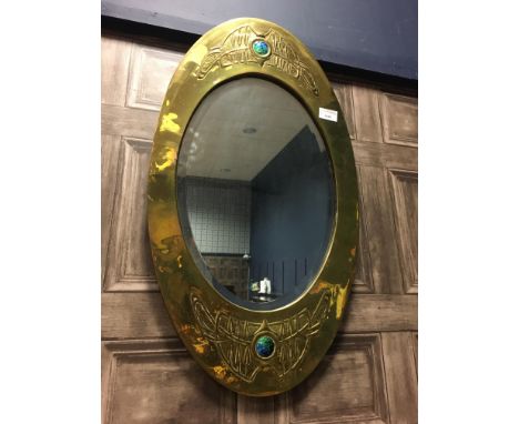 ARTS &amp; CRAFTS MARQUISE SHAPED WALL MIRROR, the brass frame embossed with Celtic bands and inset two blue enamel roundels,