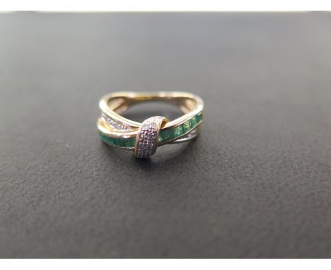 An emerald and diamond dress ring - Stamped 375 - Ring size N 1/2 - Weight approx 2.6gms 
Condition Report: Good - With light