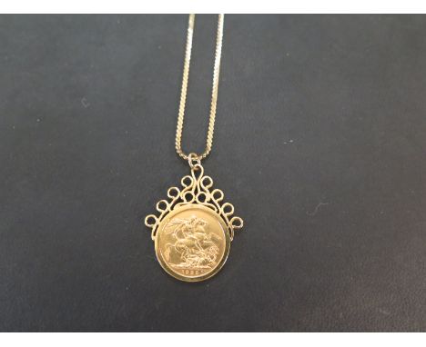 A George V, 1925 gold sovereign coin pendant - Within a 9ct gold mount - Length 4cms - Suspended from a 9ct gold fancy-link c