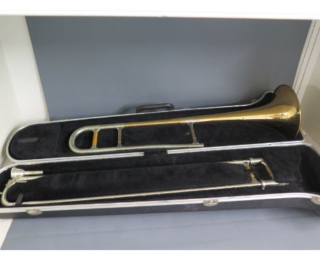 An old brass trombone with single Rotary valve in flight case