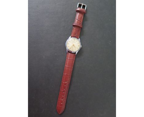 An Ingersoll seven jewel lever manual wind gents wristwatch in working order, plating worn to back but with new crocodile eff