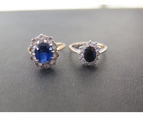 Two 9ct gold cluster rings - To include sapphire and cubic zirconia, ring size O and a blue and white-gem cluster, ring size 