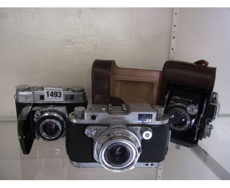 Three vintage range finder cameras to include a robot Royal Royal 36 with a Xenar 45mm lens in good condition but shutter not