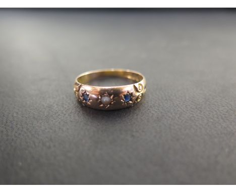 A 15ct gold sapphire and seed pearl band ring - With carved detail - Hallmarked Chester - Ring size R 1/2 - Weight approx 3.3