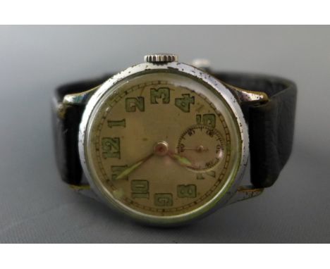 A 1930's Jaeger Le Coultre Gentleman's watch having brass case with cream dial, having broad arrow military style hands and i