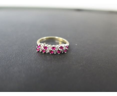 A 9ct gold ruby and diamond two-row dress ring - Hallmarked London - Ring size L - Weight approx 2.1gms
Condition Report: Goo