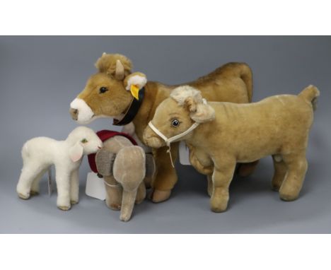 A Steiff cow with bell, 'Bertha', no. 072963, button in ear and three other Steiff toys, including a 'Lamby' lamb, with green