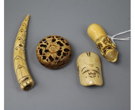 Four Japanese staghorn netsuke, 19th century including two masks, a bamboo shoot and a pomegranate manju
