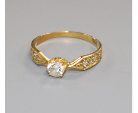 An early 20th century 18ct gold and single stone diamond ring, with diamond set shoulders, size K.