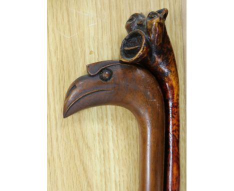 An unusual Toucan-head hardwood walking stick and a grotesque head walking stick