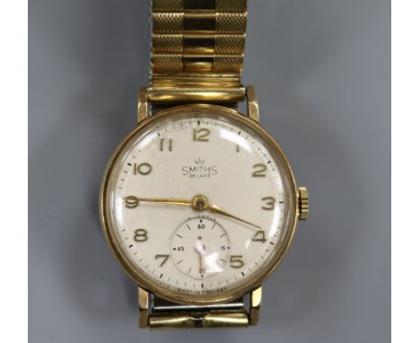 A gentleman's 9ct gold Smiths De Luxe manual wind wrist watch.